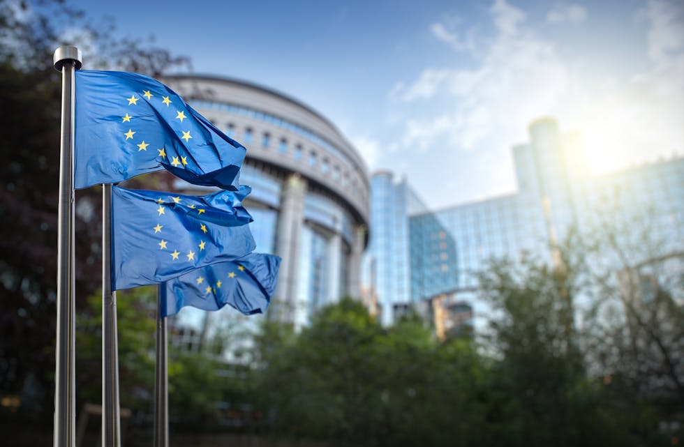 European union flag against parliament in Brussels, Belgium